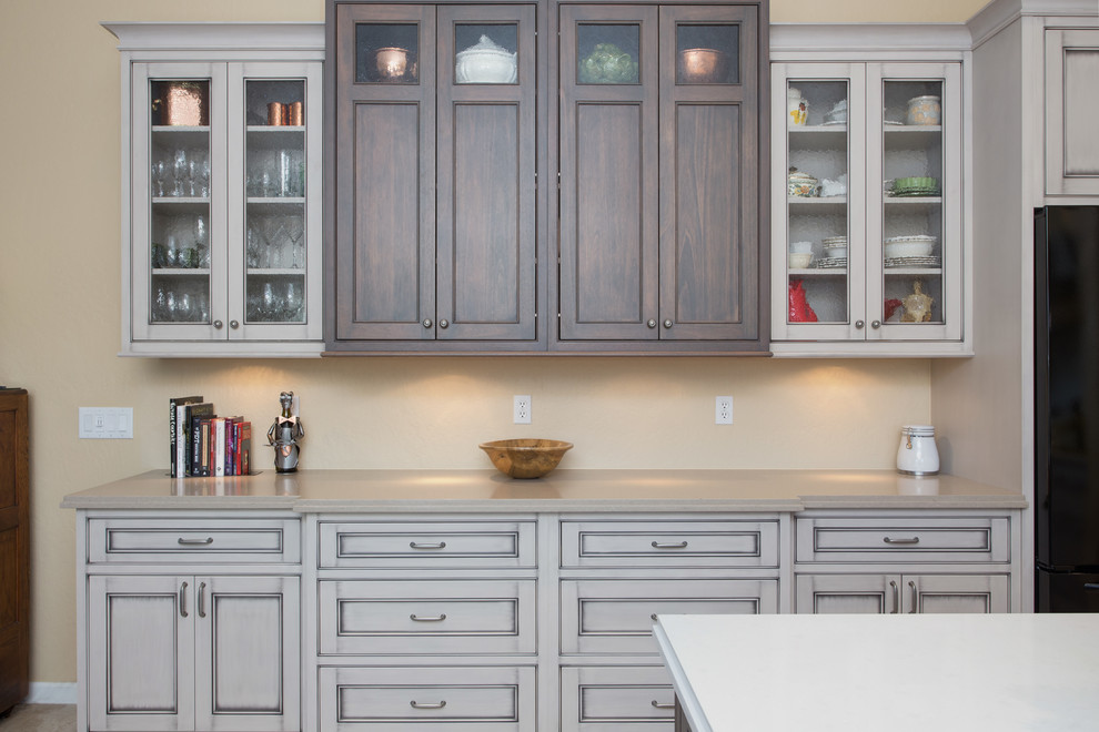 Large transitional l-shaped ceramic tile open concept kitchen photo in Phoenix with an undermount sink, beaded inset cabinets, gray cabinets, quartz countertops, white backsplash, glass tile backsplash, black appliances and an island