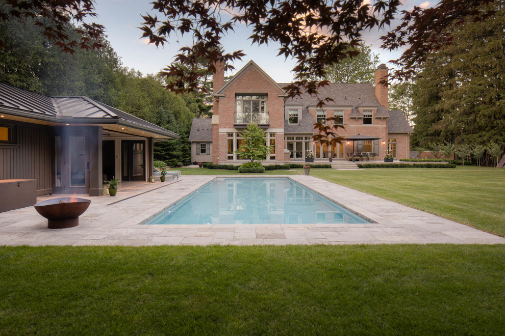 Pool house - large transitional backyard stone and rectangular lap pool house idea