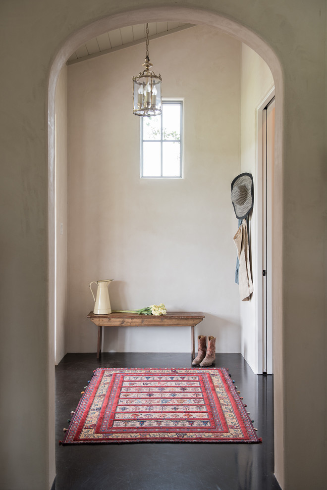 Inspiration for a small country vestibule in Austin with black floor.