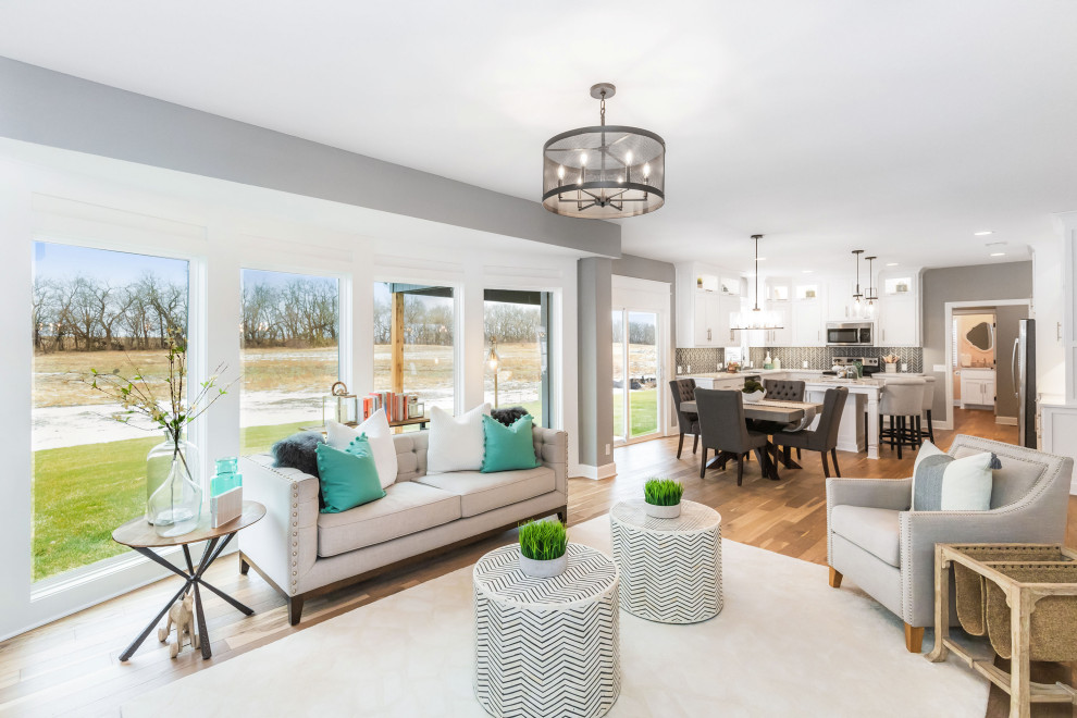 Mid-sized beach style open concept living room in Kansas City with grey walls, light hardwood floors and multi-coloured floor.