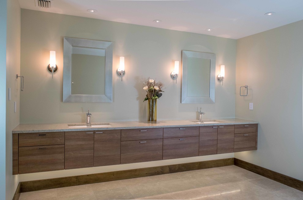 Photo of an expansive contemporary master bathroom in Miami with an integrated sink, flat-panel cabinets, medium wood cabinets, a freestanding tub, a one-piece toilet, beige tile, porcelain tile, beige walls, quartzite benchtops, an alcove shower, laminate floors, beige floor and a hinged shower door.