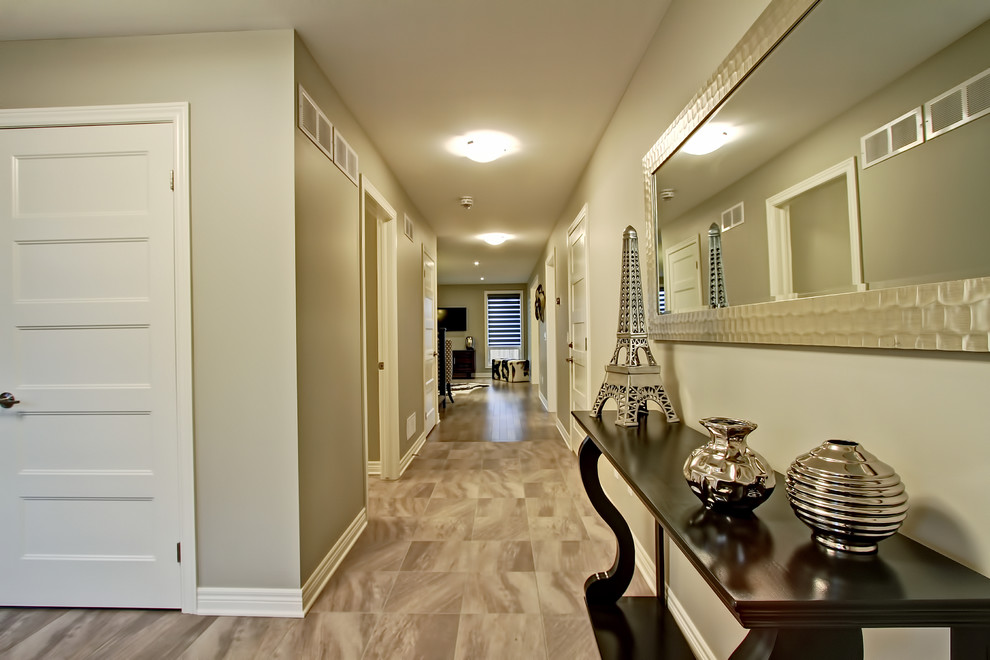 Foyer - mid-sized transitional porcelain tile foyer idea in Toronto with beige walls and a white front door