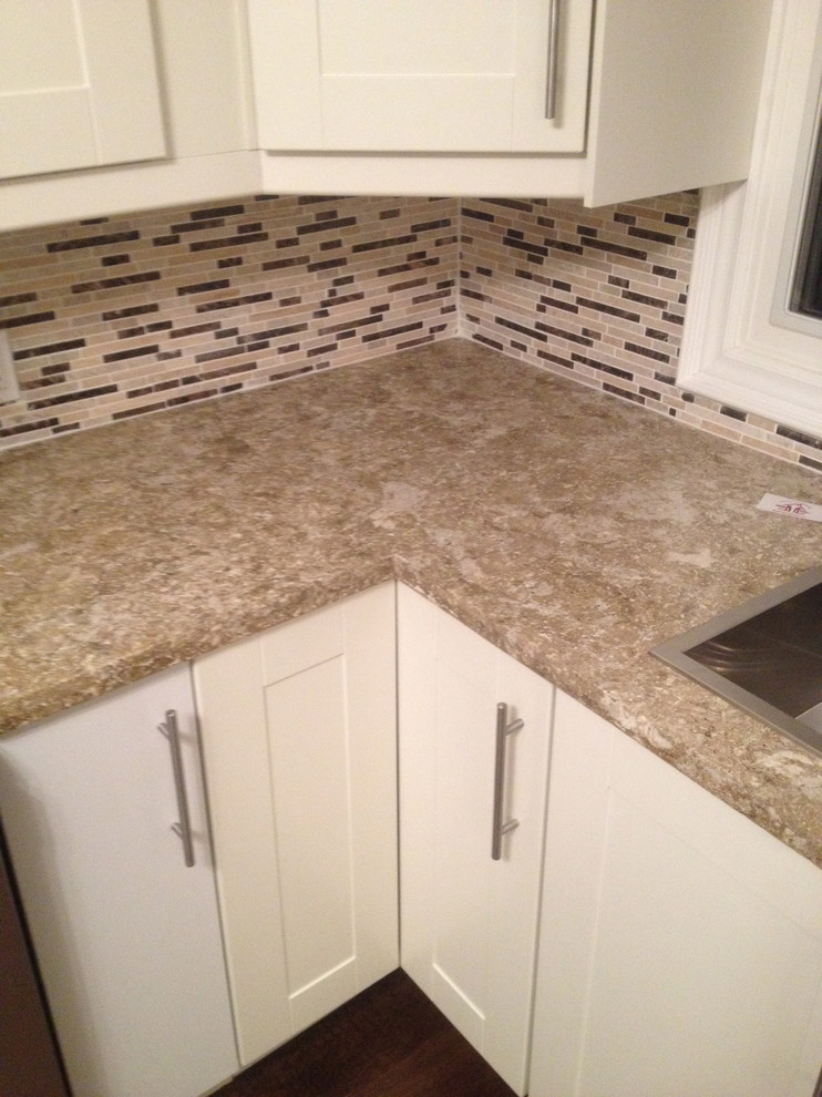 Example of a trendy kitchen design with concrete countertops