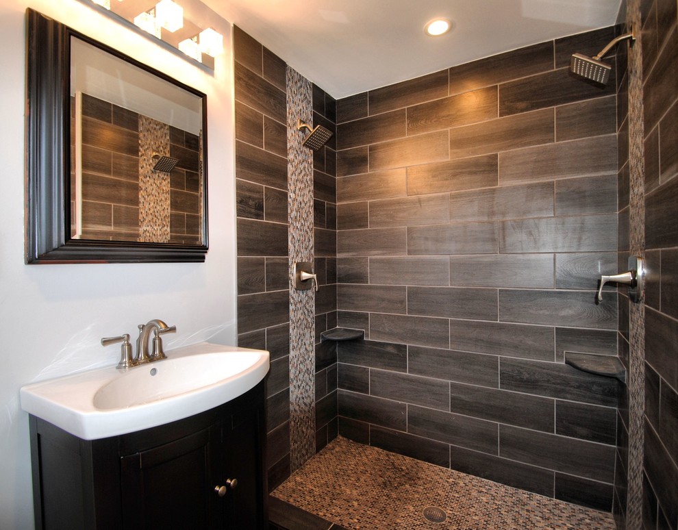Design ideas for a contemporary master bathroom in New York with furniture-like cabinets, dark wood cabinets, an open shower, a two-piece toilet, black tile, porcelain tile, blue walls, porcelain floors, an integrated sink and solid surface benchtops.