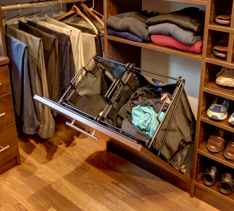 This is an example of a large traditional gender-neutral walk-in wardrobe in Other with flat-panel cabinets, dark wood cabinets, medium hardwood floors and brown floor.