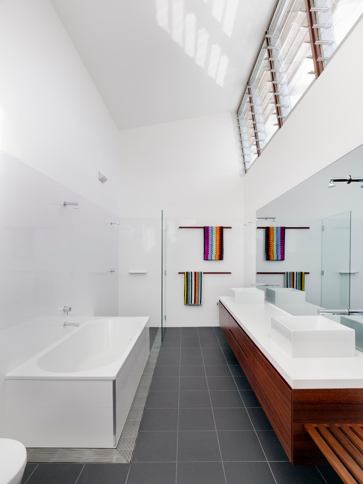 Design ideas for a contemporary bathroom in Sydney with a vessel sink, flat-panel cabinets, medium wood cabinets, a curbless shower and white benchtops.