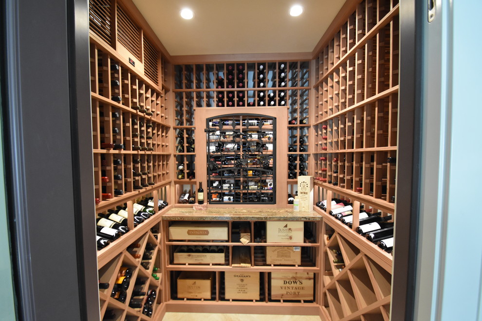 Design ideas for a mid-sized eclectic wine cellar in Orange County with ceramic floors, display racks and beige floor.
