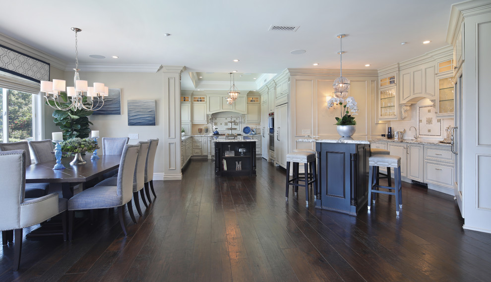 This is an example of a mid-sized transitional kitchen/dining combo in Orange County with beige walls, dark hardwood floors, no fireplace and brown floor.