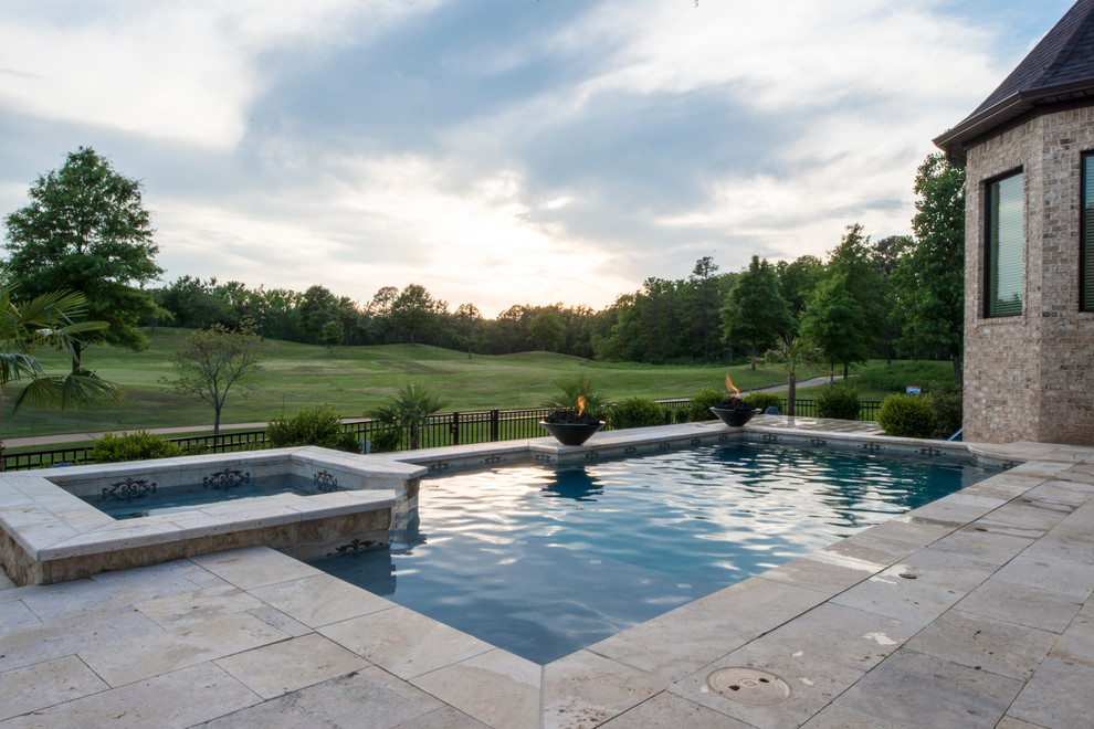This is an example of a mid-sized mediterranean backyard l-shaped lap pool in Little Rock with concrete pavers.