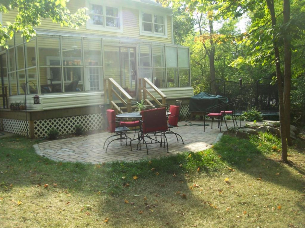This is an example of a mid-sized traditional partial sun backyard stone outdoor basketball/tennis/multi-game court in Cincinnati for spring.