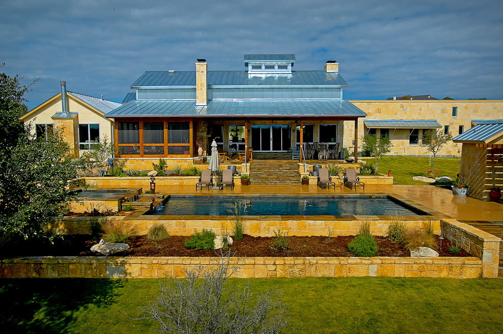 Inspiration for a large modern backyard rectangular lap pool in Austin with a hot tub and stamped concrete.
