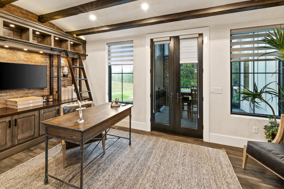 Example of a large cottage freestanding desk dark wood floor and brown floor study room design in Cincinnati with no fireplace and beige walls