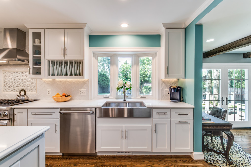 Large transitional galley medium tone wood floor and brown floor eat-in kitchen photo in DC Metro with a farmhouse sink, shaker cabinets, white cabinets, quartz countertops, white backsplash, ceramic backsplash, stainless steel appliances, an island and white countertops
