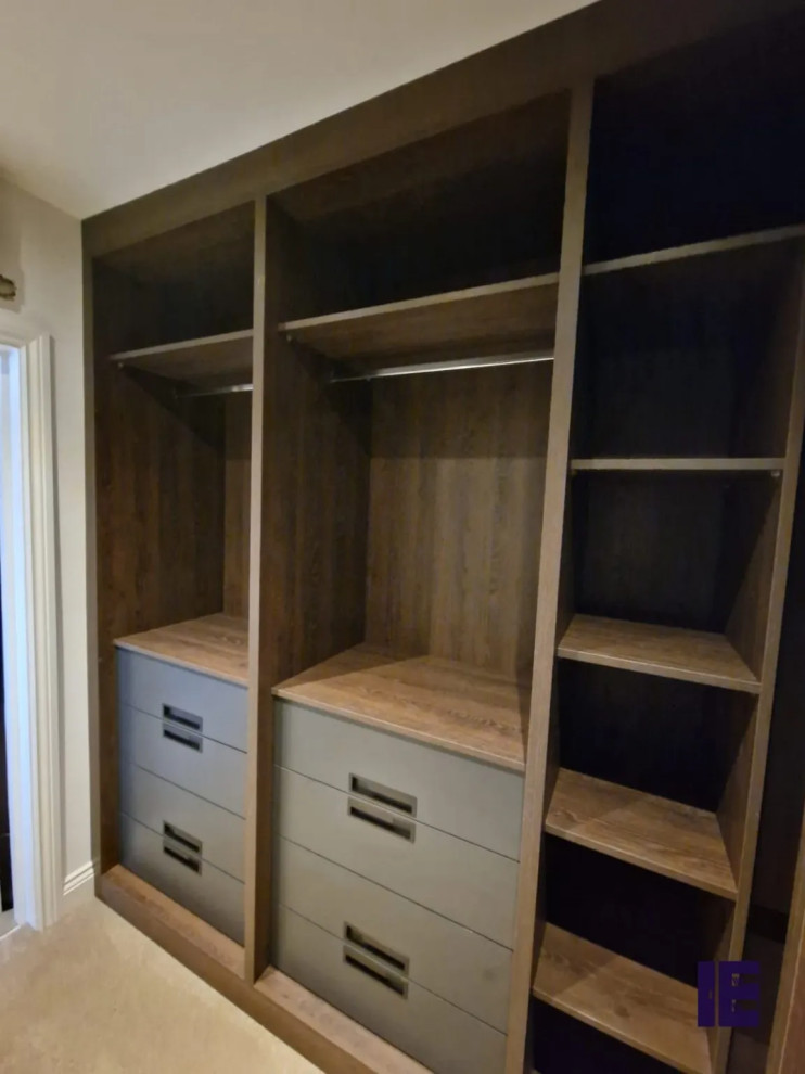 Inspiration for a small modern walk-in wardrobe in London with open cabinets, medium wood cabinets and feature lighting.