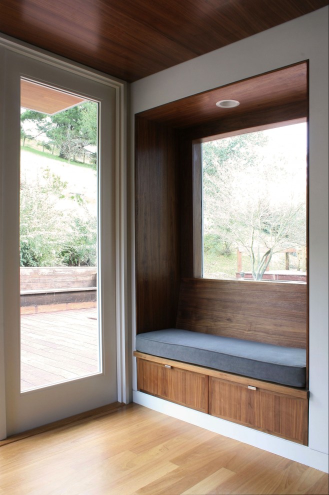 Transitional mudroom in San Francisco with a glass front door, white walls and light hardwood floors.
