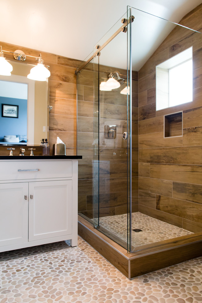 Inspiration for a small contemporary 3/4 bathroom in San Luis Obispo with an undermount sink, furniture-like cabinets, white cabinets, soapstone benchtops, a corner shower, porcelain tile, beige walls and pebble tile floors.