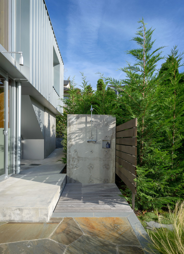 Inspiration for a contemporary backyard patio in Seattle with an outdoor shower and no cover.