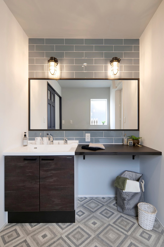 This is an example of a mid-sized contemporary 3/4 bathroom in Other with flat-panel cabinets, gray tile, subway tile, white walls, an integrated sink, grey floor, white benchtops, a single vanity and a built-in vanity.