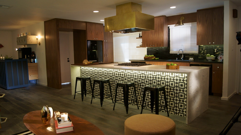 Photo of a mid-sized midcentury l-shaped open plan kitchen in Sacramento with an undermount sink, flat-panel cabinets, medium wood cabinets, quartz benchtops, black splashback, stone tile splashback, black appliances, medium hardwood floors, with island and brown floor.