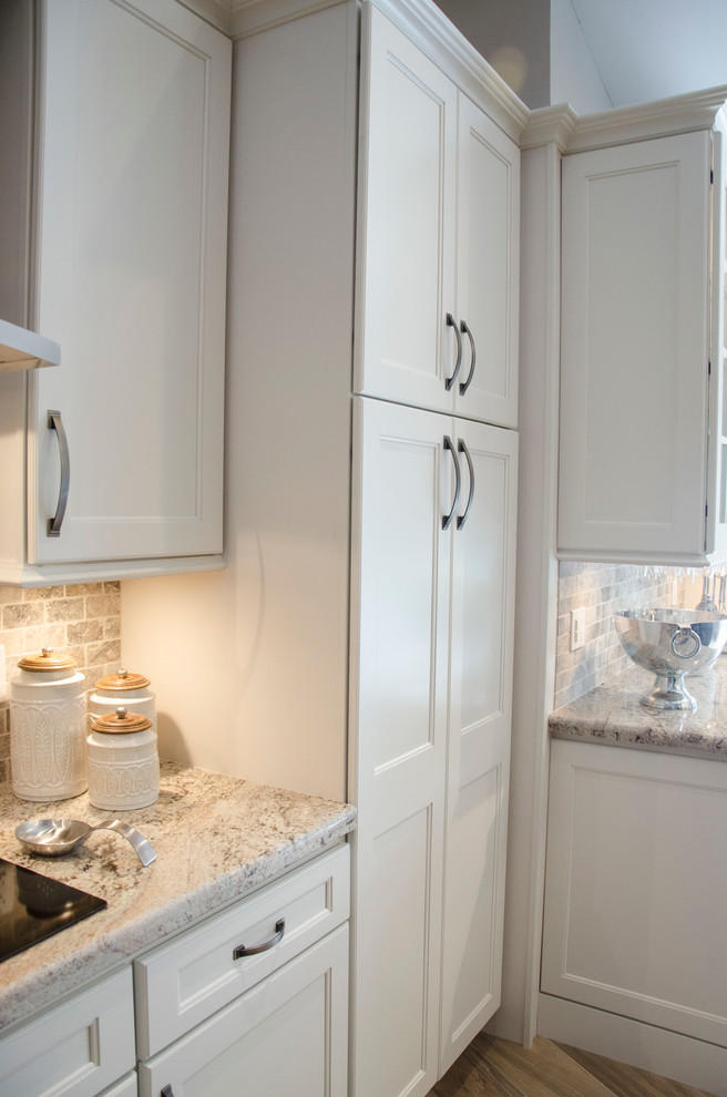 Open concept kitchen - large transitional porcelain tile open concept kitchen idea in Miami with an undermount sink, shaker cabinets, granite countertops, multicolored backsplash, stone tile backsplash, stainless steel appliances and an island