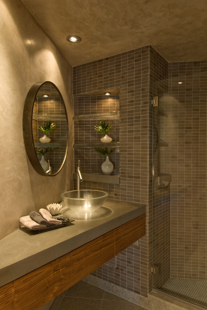 This is an example of a contemporary bathroom in Other with concrete benchtops, mosaic tile and a vessel sink.