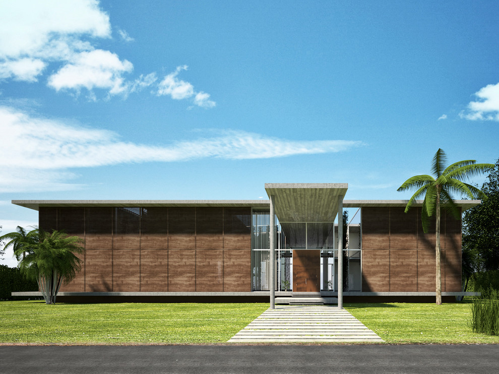 Photo of a mid-sized tropical two-storey concrete brown exterior in Miami with a flat roof.
