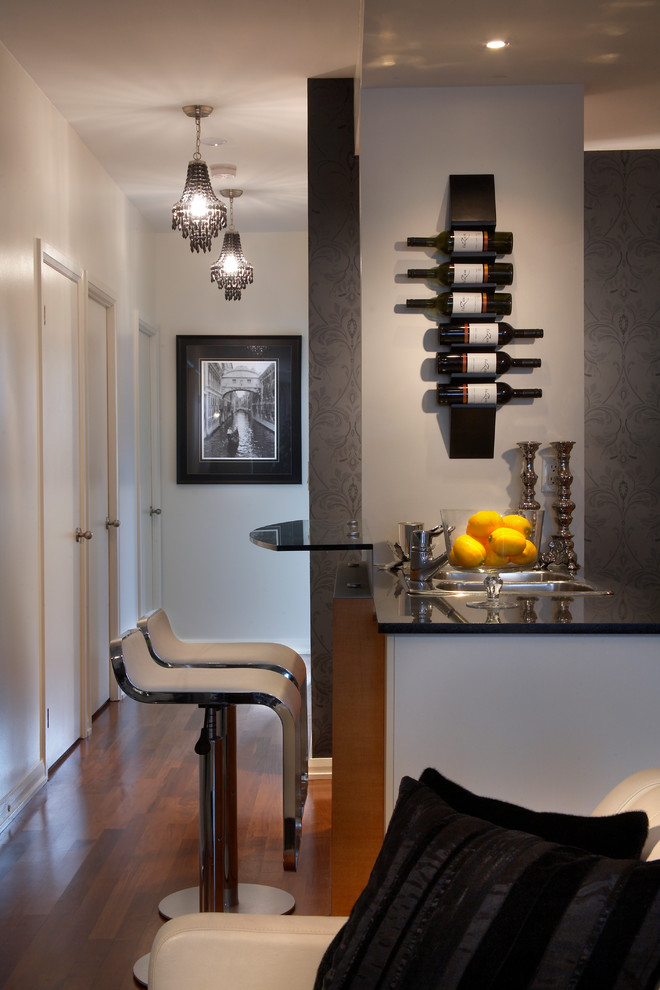 Contemporary seated home bar in Toronto with dark hardwood floors and a drop-in sink.