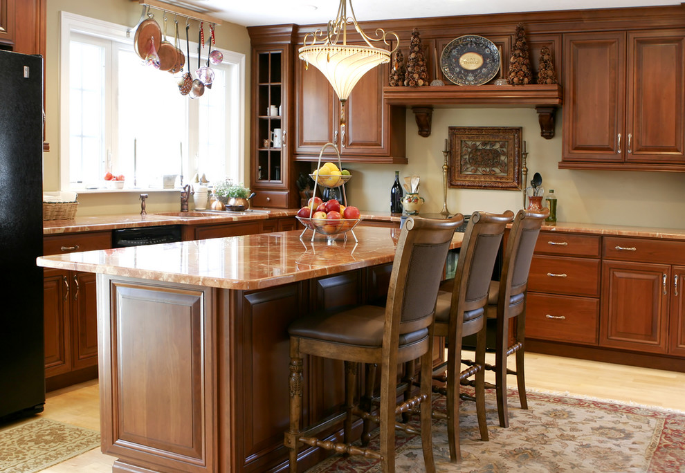 Inspiration for a mid-sized l-shaped light wood floor kitchen remodel with raised-panel cabinets, medium tone wood cabinets, granite countertops, black appliances and an island