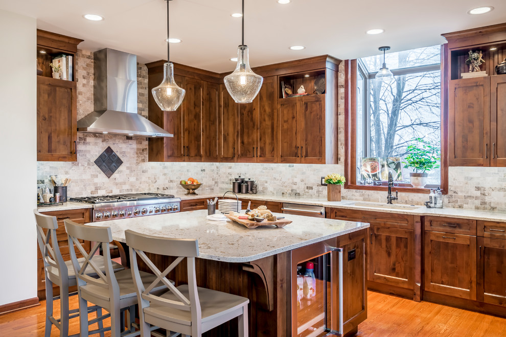 Inspiration for a rustic l-shaped medium tone wood floor and brown floor kitchen remodel in Chicago with an undermount sink, shaker cabinets, dark wood cabinets, gray backsplash, stainless steel appliances and gray countertops