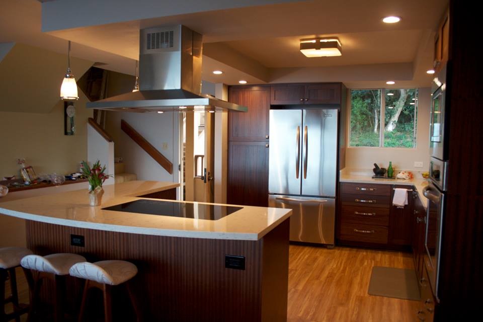 Inspiration for a large transitional l-shaped light wood floor eat-in kitchen remodel in Houston with a drop-in sink, shaker cabinets, dark wood cabinets, quartzite countertops, blue backsplash, glass tile backsplash, stainless steel appliances and an island
