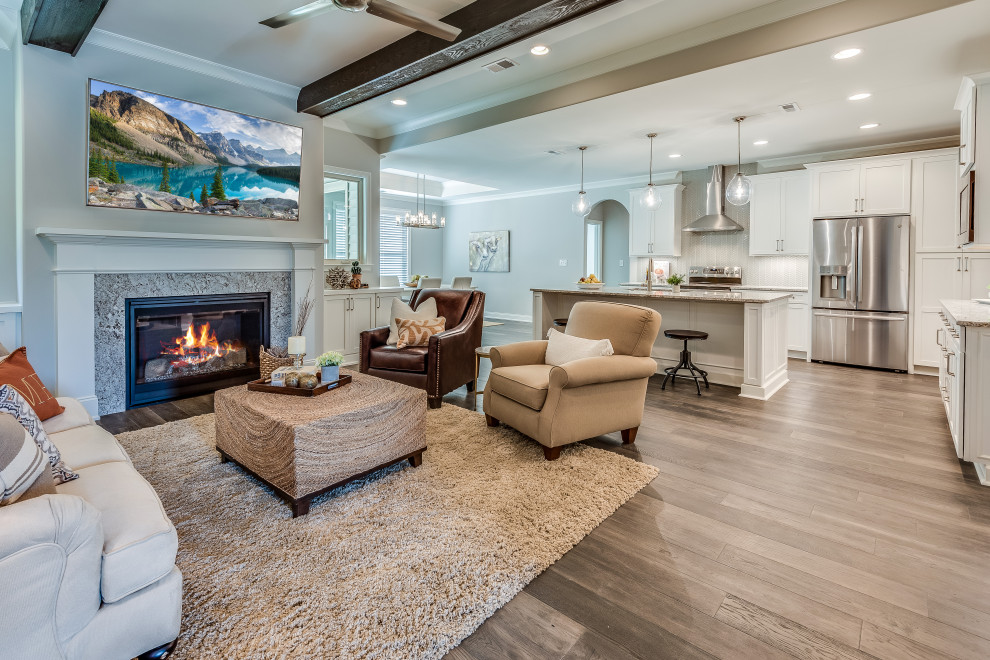 Mid-sized transitional l-shaped open concept kitchen photo with an undermount sink, flat-panel cabinets, white cabinets, quartz countertops, white backsplash, glass tile backsplash, stainless steel appliances, an island and white countertops