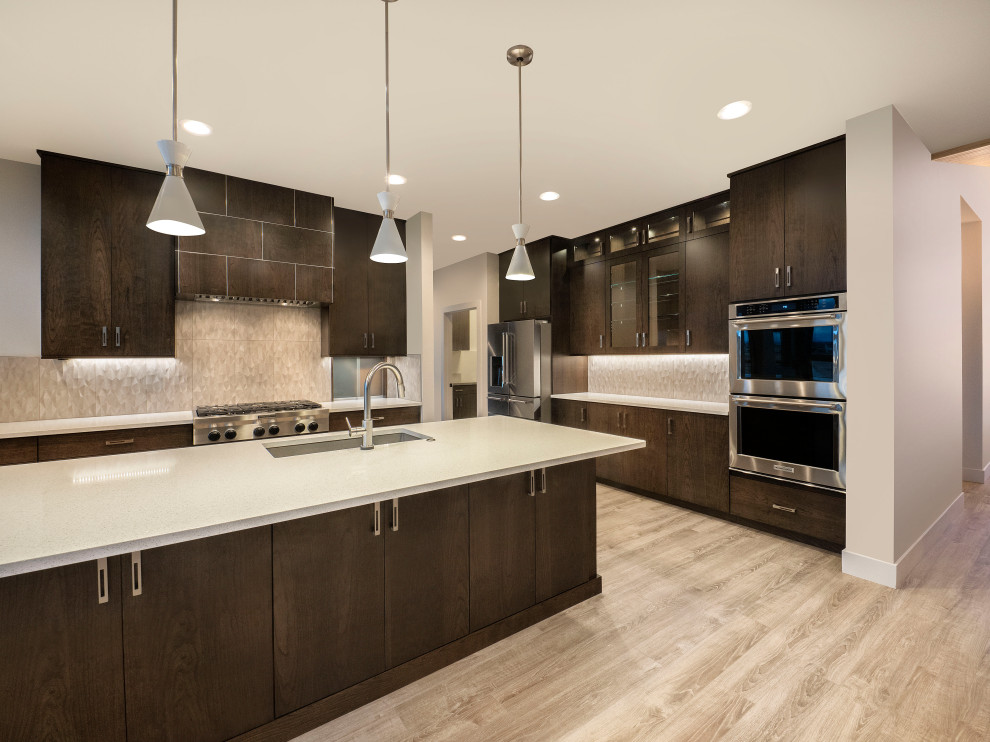 Design ideas for a mid-sized contemporary l-shaped open plan kitchen in Denver with an undermount sink, flat-panel cabinets, dark wood cabinets, quartz benchtops, beige splashback, porcelain splashback, stainless steel appliances, light hardwood floors, with island, beige floor and white benchtop.
