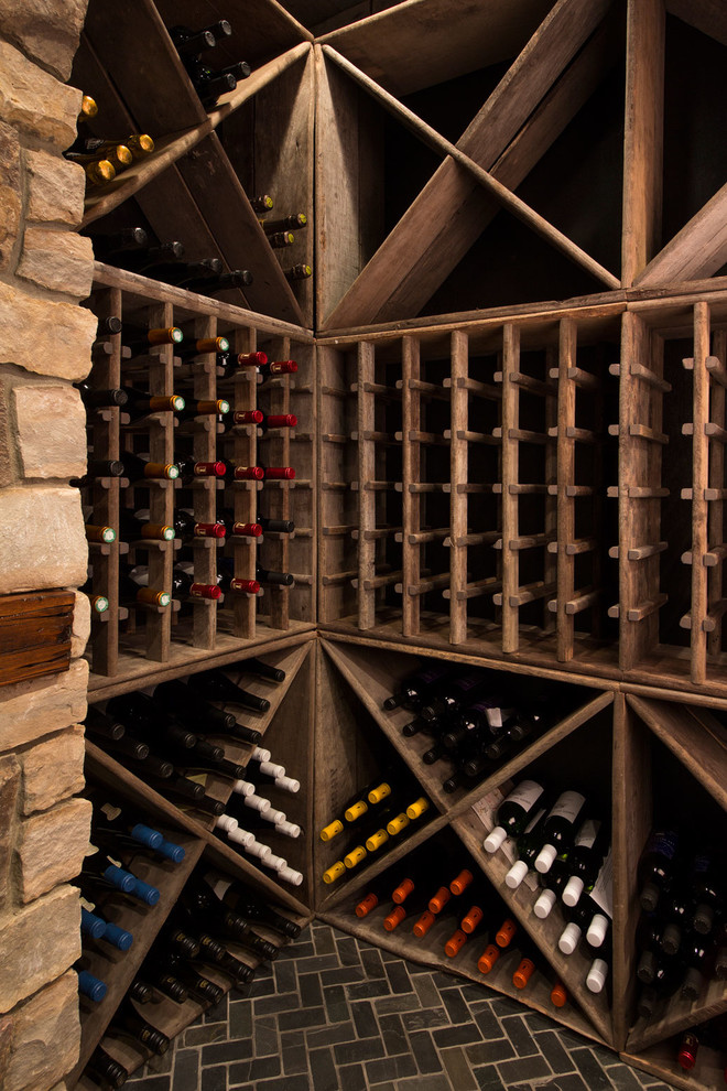 Photo of a mid-sized traditional wine cellar in Detroit with brick floors and diamond bins.