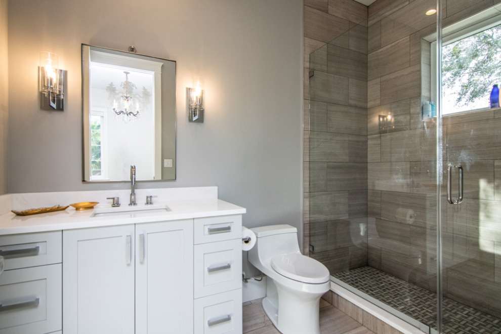Medium sized classic bathroom in Tampa with an alcove shower, a one-piece toilet, beige tiles, ceramic tiles, grey walls, ceramic flooring, a submerged sink, quartz worktops, beige floors, an open shower, white worktops, a single sink and wallpapered walls.
