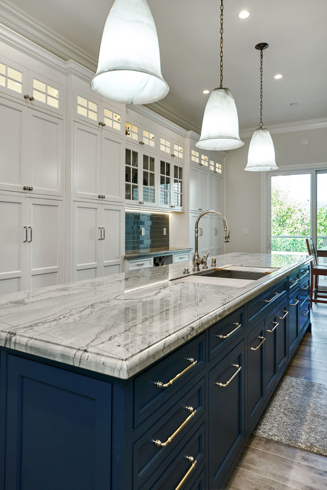 Example of a large classic u-shaped porcelain tile and gray floor kitchen pantry design in San Francisco with a triple-bowl sink, beaded inset cabinets, white cabinets, quartzite countertops, blue backsplash, ceramic backsplash, paneled appliances, an island and blue countertops