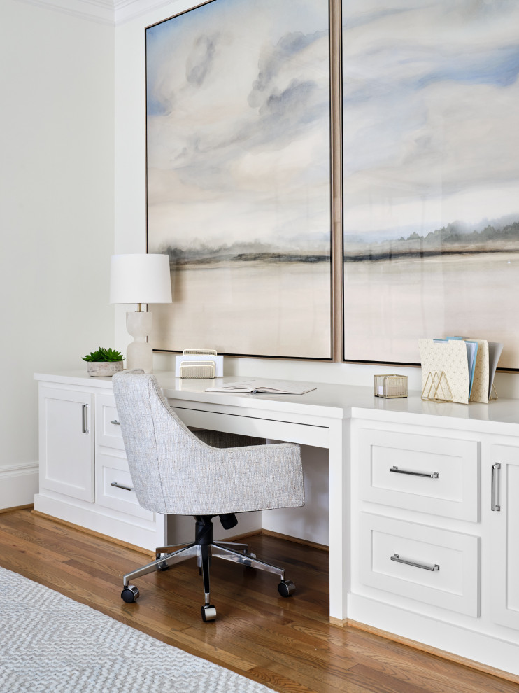 Inspiration for a mid-sized coastal built-in desk medium tone wood floor and brown floor study room remodel in Houston with white walls, a standard fireplace and a stone fireplace