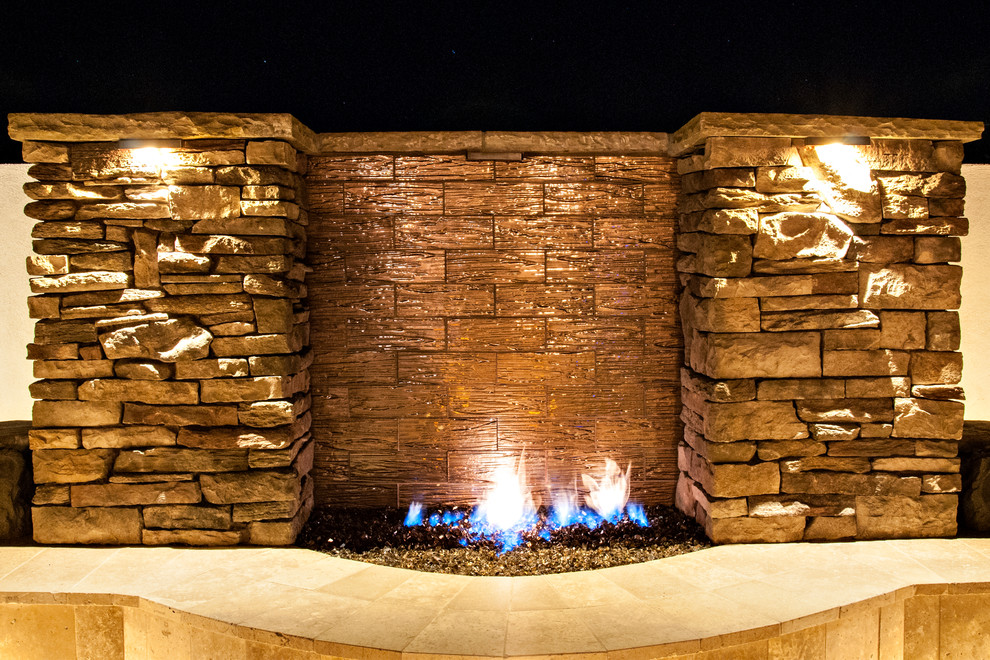 Example of a transitional backyard stone home design design in Phoenix with a fire pit
