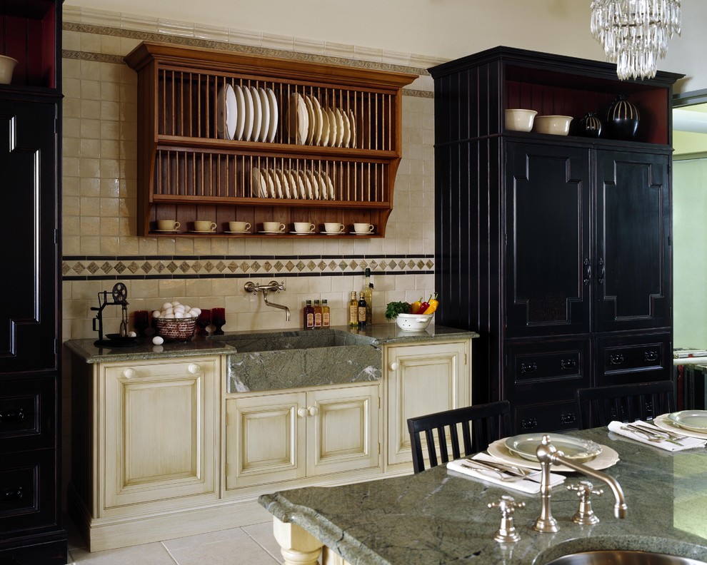 This is an example of a traditional kitchen in Boston with an integrated sink, black cabinets and granite benchtops.