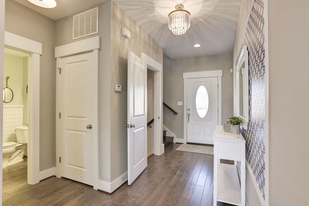 Design ideas for a small country entry hall in Baltimore with grey walls, medium hardwood floors, a single front door and a dark wood front door.