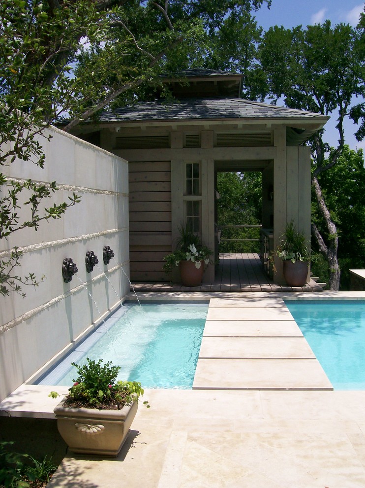 Inspiration for a traditional rectangular pool in Dallas with a water feature.