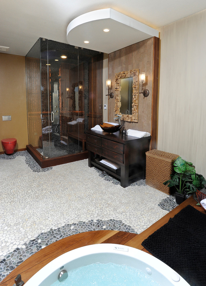 Mid-sized eclectic bathroom in Other with a vessel sink, flat-panel cabinets, distressed cabinets, wood benchtops, a japanese tub, a wall-mount toilet, multi-coloured tile, stone tile, multi-coloured walls, pebble tile floors, with a sauna and a corner shower.