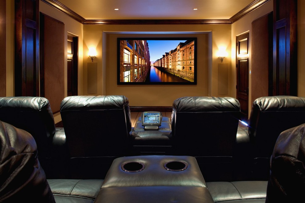 This is an example of a contemporary enclosed home theatre in Phoenix with beige walls and a wall-mounted tv.