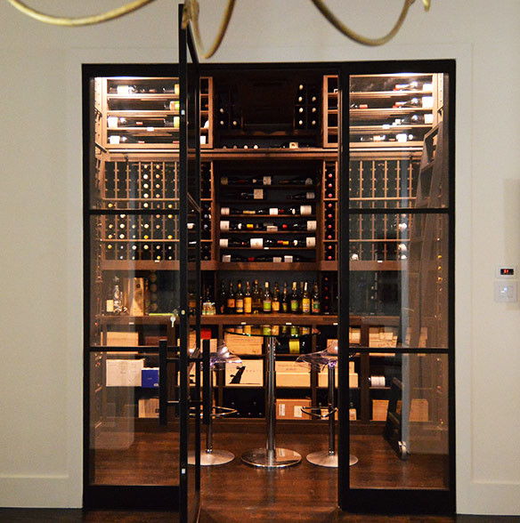 This is an example of a mid-sized transitional wine cellar in Los Angeles with storage racks, dark hardwood floors and brown floor.