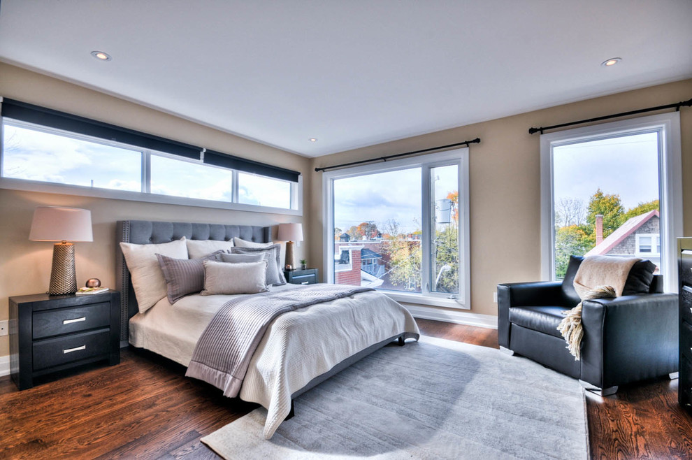 This is an example of a mid-sized transitional master bedroom in Ottawa with beige walls, dark hardwood floors and brown floor.