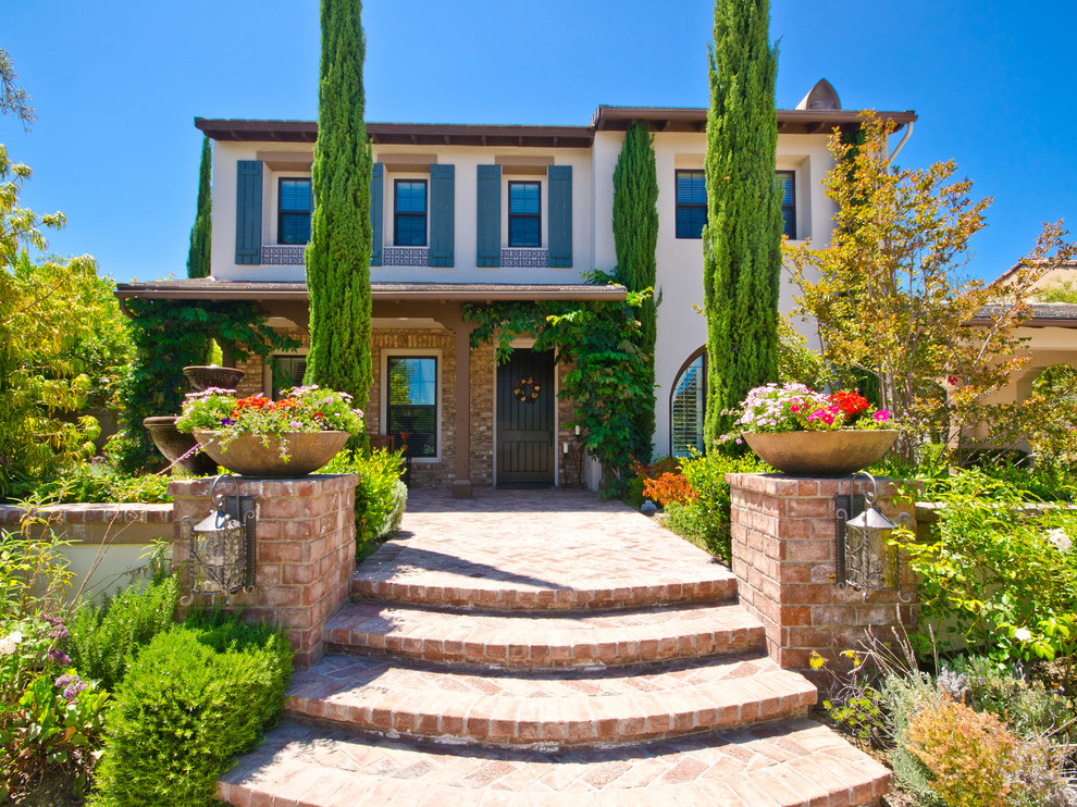 Design ideas for a mid-sized mediterranean two-storey exterior in San Diego.