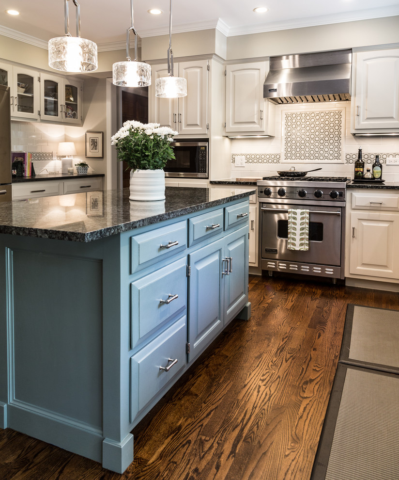 Example of a large transitional u-shaped brown floor and dark wood floor eat-in kitchen design in Chicago with an undermount sink, raised-panel cabinets, white cabinets, granite countertops, white backsplash, stainless steel appliances, an island and subway tile backsplash
