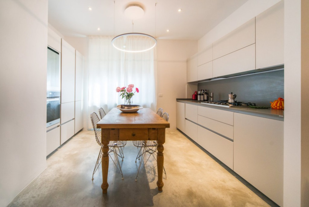 Medium sized contemporary galley kitchen/diner in Other with a submerged sink, grey cabinets, engineered stone countertops, grey splashback, engineered quartz splashback, stainless steel appliances, concrete flooring, grey floors, grey worktops and a drop ceiling.