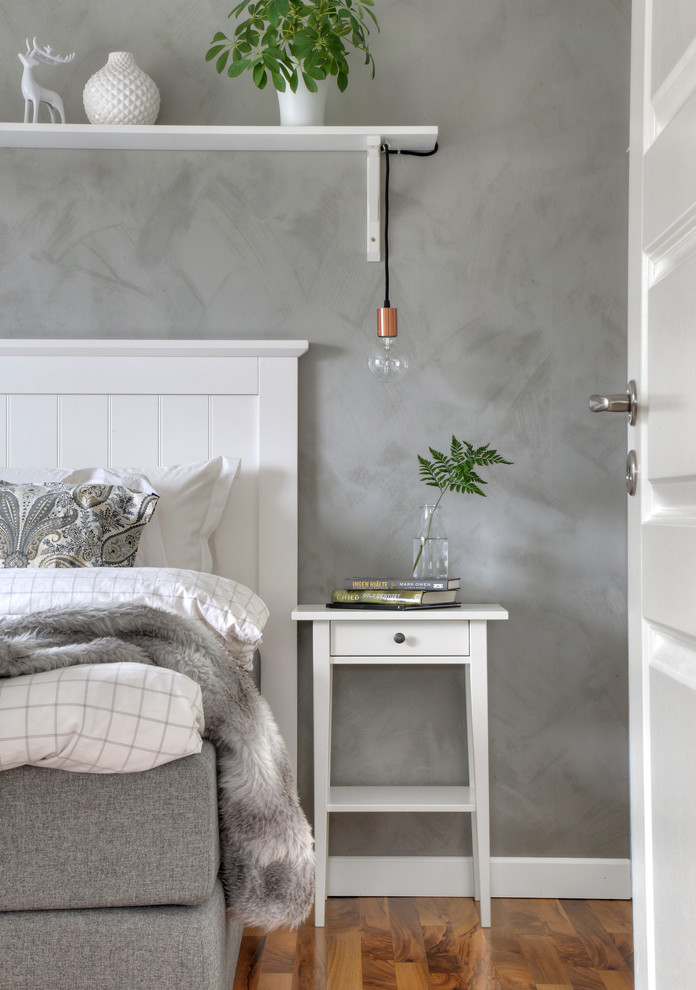 Design ideas for a transitional bedroom in Gothenburg with grey walls, medium hardwood floors and brown floor.