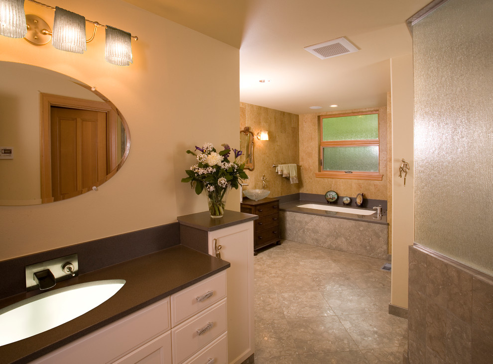 Transitional bathroom in Seattle with raised-panel cabinets, white cabinets, a drop-in tub, an alcove shower, beige walls, an undermount sink and soapstone benchtops.