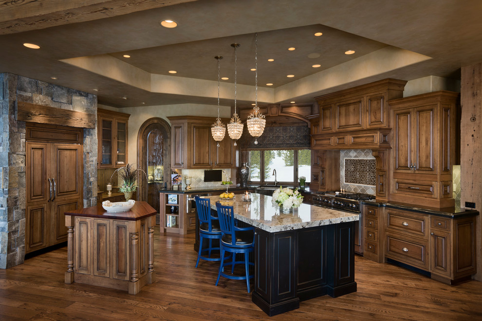 Design ideas for a traditional kitchen in Other with raised-panel cabinets and dark wood cabinets.